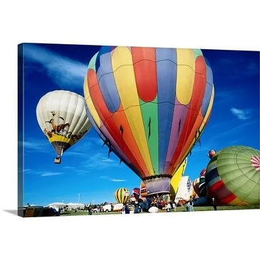 Judy Bellah Premium Thick-Wrap Canvas entitled Colorful hot air balloons floating up into a blue sky